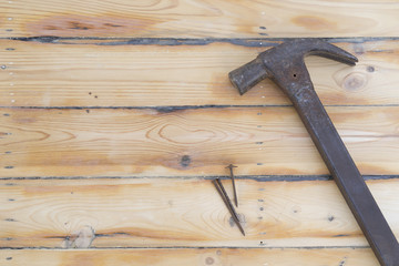 Hammer with nail on wood