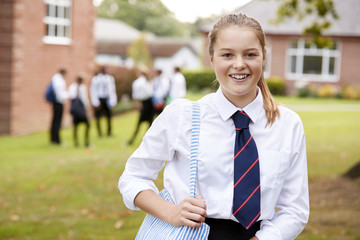 Portrait Of Female Teenage Student In Uniform Outside Buildings