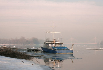 Fototapeta premium Boat on river in winter