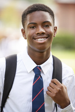 Portrait Of Male Teenage Student In Uniform Outside Buildings