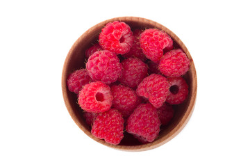 red raspberries in wooden cup isolated