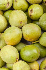 Green walnuts in a pile