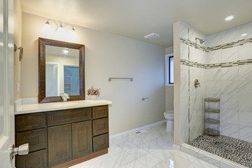 Fototapeta na wymiar Bright clean bathroom interior with espresso vanity cabinet