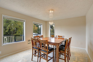 Beige light filled dining room with wooden dining table set