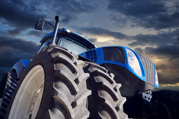 Powerful tractor on sunset background © VeremeeV_1980