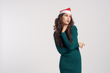 2084051 beautiful woman in green dress and christmas hat posing, light background, free space for copy, holiday, new year, christmas, winter