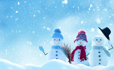 Merry Christmas and happy New Year greeting card with copy-space.Many snowmen standing in winter Christmas landscape.Winter background