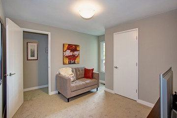 Gray room with sofa and TV.