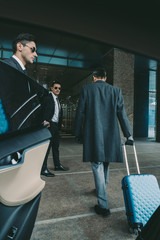 businessman going with blue travel bag to airport - obrazy, fototapety, plakaty