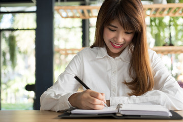 start up woman work in cafe. female student  write note in notebook in coffee shop. education, lifestyle, business, people concept.