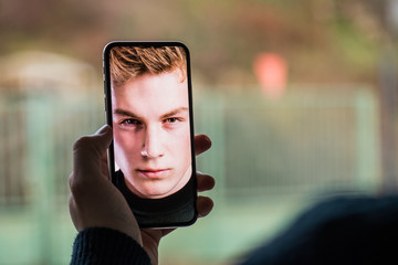 A smartphone using face ID recognition system.