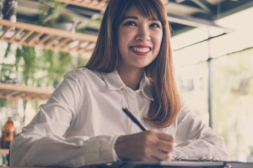 start up woman work in cafe. female student  write note in notebook in coffee shop. education, lifestyle, business, people concept.