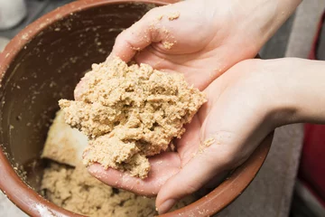 Fotobehang 糠漬けを作る女性の手 © hakase420