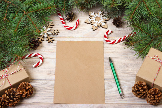 Empty Christmas Card On Wooden Table With Christmas Candy And Gift Box