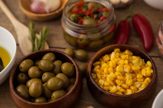 High angle view of corns and green olives