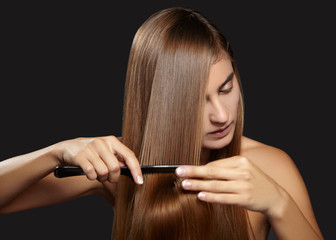 Hair care photo. Beautiful woman after Bath Hairbrushing Healthy Straight Brown Hair. Model Brushing Her Long Hair