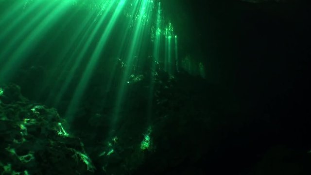 Reflection of sunlight in caves of Yucatan cenotes underwater. Clean and clear underground water in Mexico.