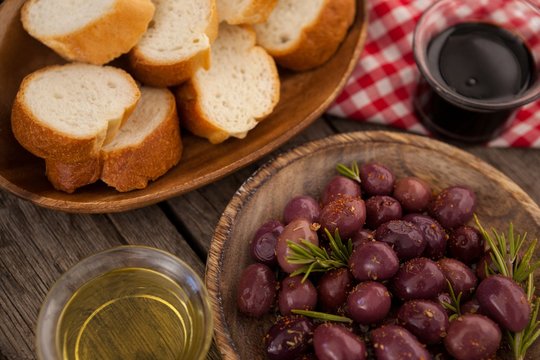 Olives and bread with oil on table