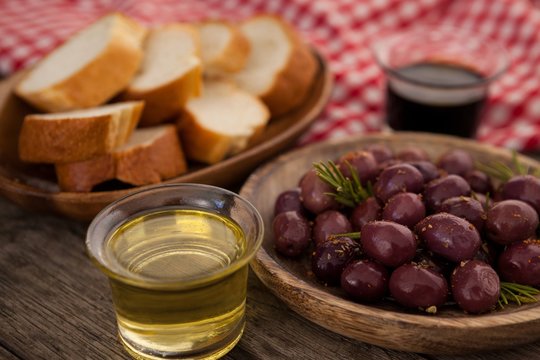 Olives and bread with oil in container
