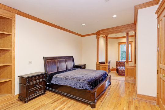 Welcoming mansion bedroom with a light hardwood floor
