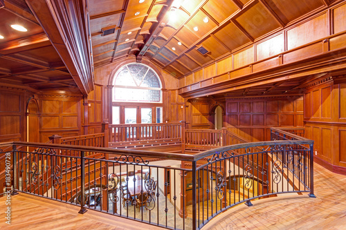 Second Floor Landing Accented With Wood Paneled Walls And
