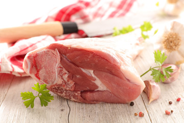 raw lamb leg and spices