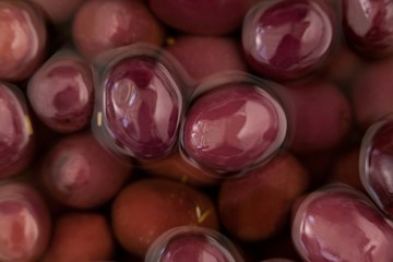 Close up of red olives in oil