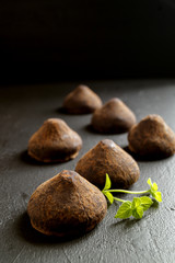 Chocolate truffles on a grey background.