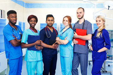 Multiracial team of young doctors in a hospital standing in a operating room - 183492579