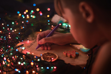 Boy writes a letter to Santa, cristmas background