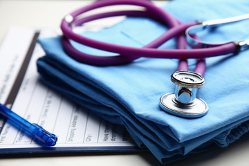 Doctor coat with medical stethoscope on the desk