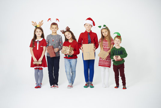 Full length portrait of children with christmas gift