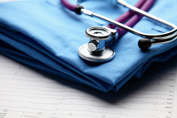 Doctor coat with medical stethoscope on the desk