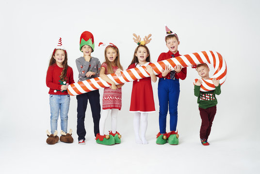 Children with artificial candy cane .