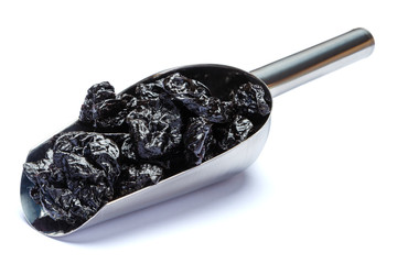 Scoop full of Dried Prunes isolated on white background. Clipping path