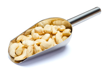 Scoop full of Roasted cashew nuts isolated on white background. Clipping path