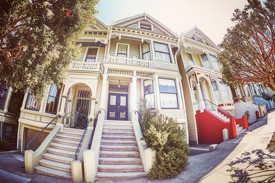 Vintage stylized fisheye lens picture of the Painted Ladies houses seen from the street, San Francisco, USA.