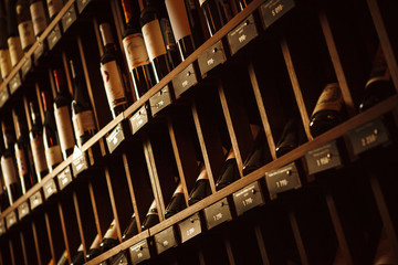 Wine cellar with elite drinks on shelves with written names