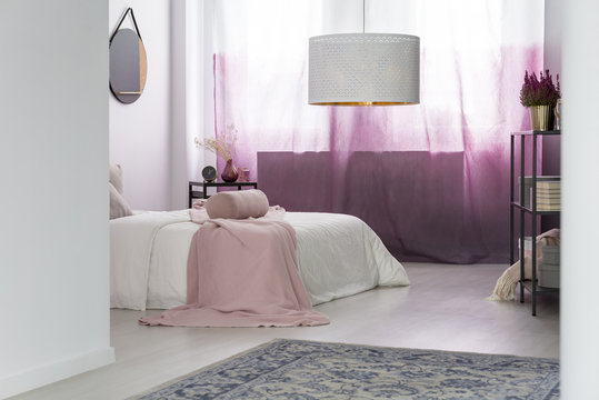 White lamp in pink bedroom
