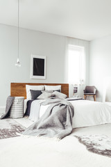 Black poster in bright bedroom