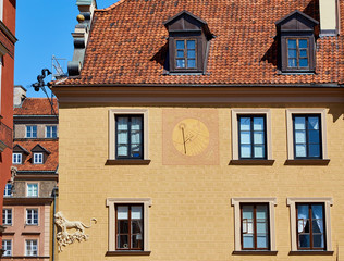 Sundial on one of the facades of an old building in the historic center of the center of Warsaw, Poland
