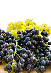 Bunches of fresh white and black seedless grapes