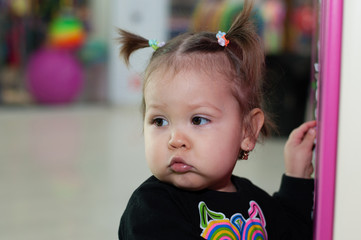 baby girl with two tails of hair on head