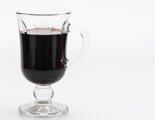 Domestic wine. Glass of red hot wine on white background