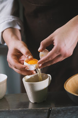 The chef separates the whites then yolks in restaurant