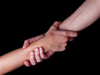 Man saving, rescuing and helping woman by holding or griping the forearm. Male hand and arm pulling...
