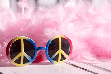 Hippie style: peace sign sunglasses and pink feather boa