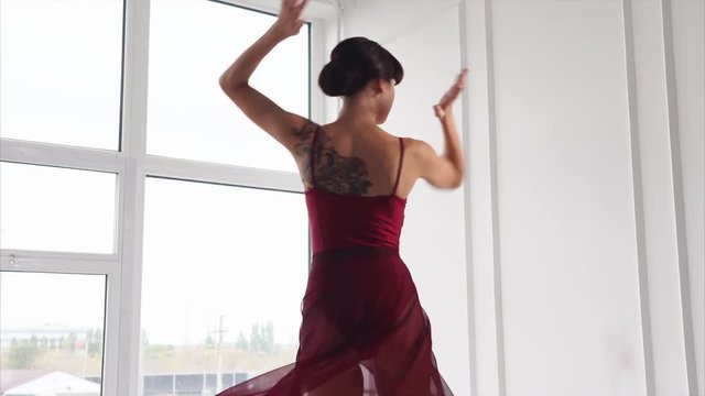 Graceful woman dancer having a training in the ballroom. Passionate performance