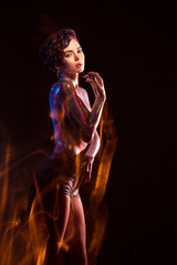 Fototapeta premium Sexy woman covered with glitter with lighting photo effects