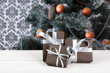 Christmas presents on decorated tree background, holiday concept